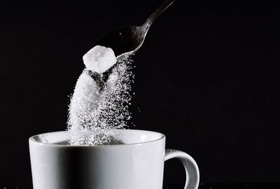 Close-up of coffee cup over black background