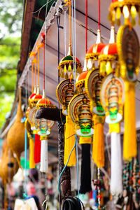 Low angle view of decorations hanging for sale at market