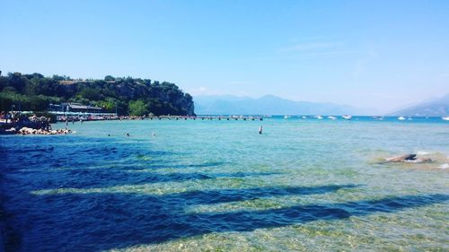 View of calm beach against blue sky