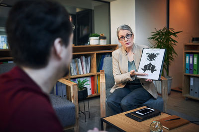 Doctor showing rorschach test to patient