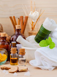 Spices with various objects on wooden table