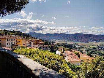 Townscape by mountains against sky