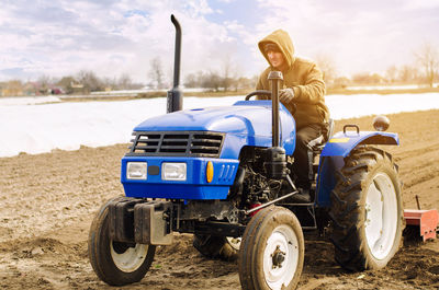 Farmer on a tractor with milling machine loosens, grinds and mixes soil. loosening the surface