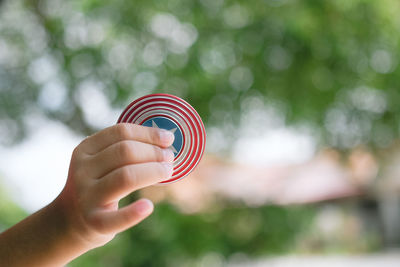 Close-up of hand holding finger against blurred background