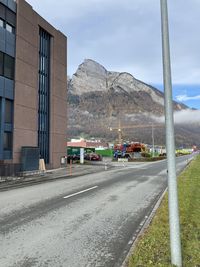 Road by mountain against sky