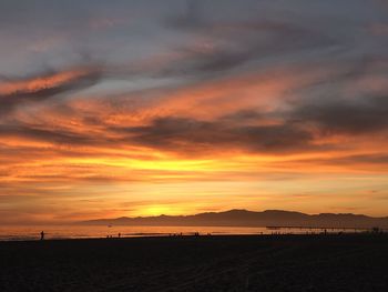 Scenic view of beach against sky during sunset
