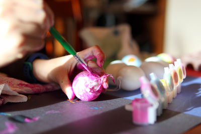 Midsection of woman painting on table