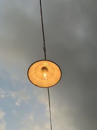 Low angle view of light bulb against sky