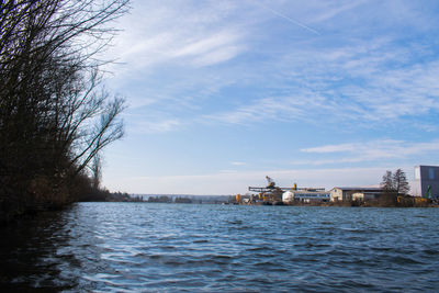 Scenic view of sea by buildings against sky