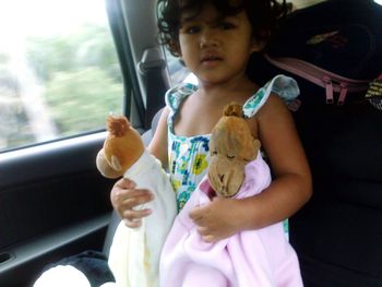 Girl eating ice cream while sitting in car