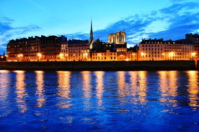 River with buildings in background at sunset