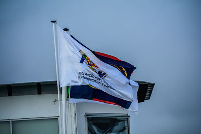 Low angle view of flag against blue sky