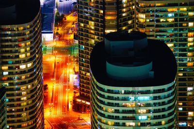 Illuminated modern buildings in city at night