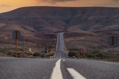 Empty road against mountain