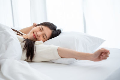 Young woman sleeping on bed