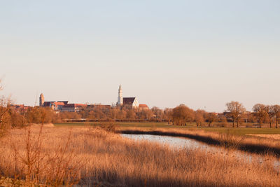 Scenic view of field against clear sky