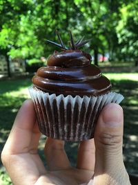 Close-up of hand holding ice cream cone