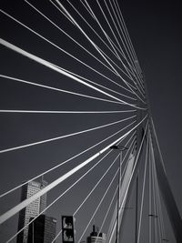 Low angle view of suspension bridge against sky