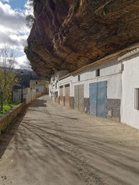 Road amidst buildings against sky