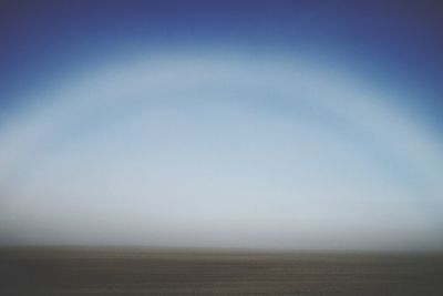 Scenic view of landscape against blue sky