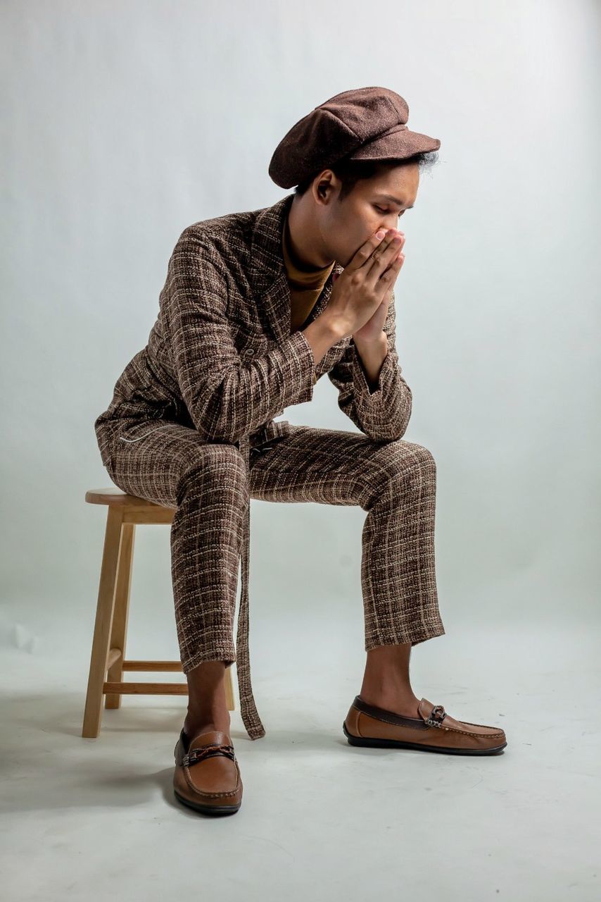 one person, full length, casual clothing, looking, hat, indoors, young adult, seat, fashion, clothing, lifestyles, real people, looking away, young women, sitting, chair, standing, adult, contemplation, hairstyle