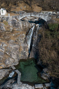 High angle view of stream flowing through rocks