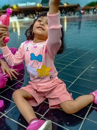 Rear view of girl playing in water