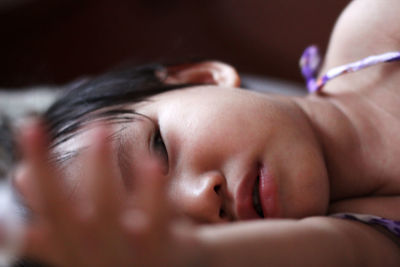 Close-up of girl lying on bed
