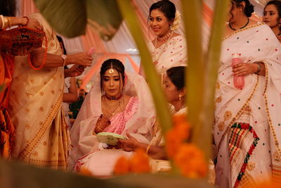 Portrait of smiling friends in traditional clothing