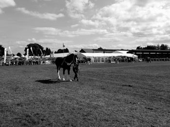 Group of people on field against sky