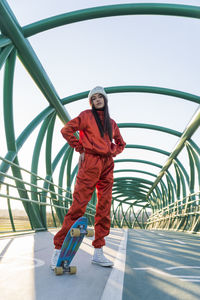 Portrait of man standing on railing against sky