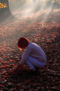 Side view of baby girl on field during autumn