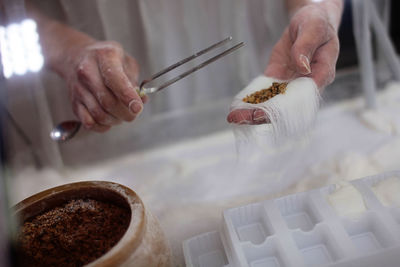 Midsection of person making dragon beard candy in kitchen