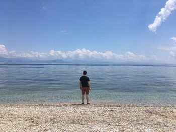 Rear view of man standing on beach