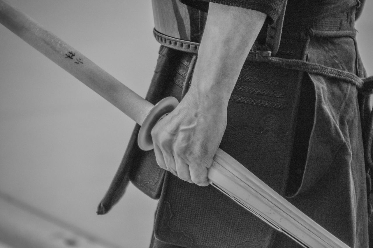 CLOSE-UP OF MAN STANDING WITH HAND