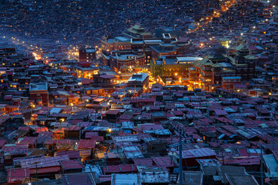 High angle view of illuminated buildings in city at night