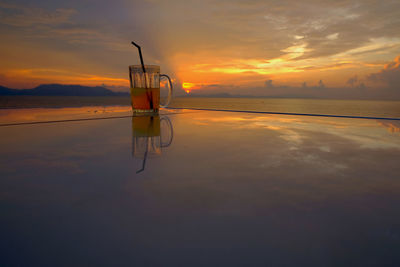 Scenic view of lake against sky during sunset