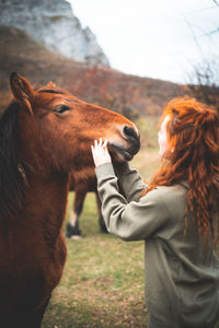 Woman with horse on field