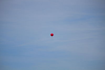 Low angle view of balloons against sky