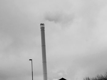 Low angle view of street light against cloudy sky