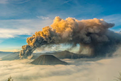 Smoke emitting from volcanic bromo mountain against sky