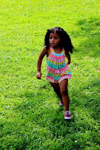 Portrait of girl playing on grassy field