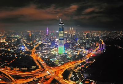 Aerial view of city lit up at night