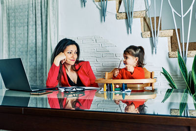 Portrait of friends sitting on table
