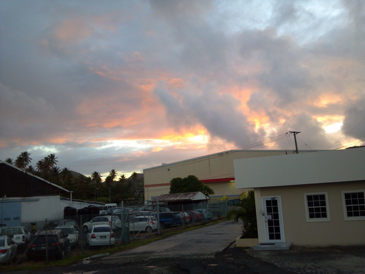 building exterior, sky, cloud - sky, architecture, built structure, sunset, cloudy, transportation, house, car, mode of transport, residential structure, land vehicle, weather, residential building, cloud, street, overcast, road, town