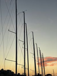 Low angle view of silhouette sailboats against sky at sunset