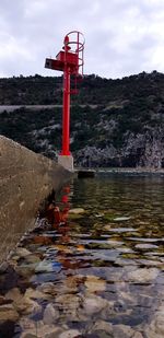 Lifeguard hut in water against sky