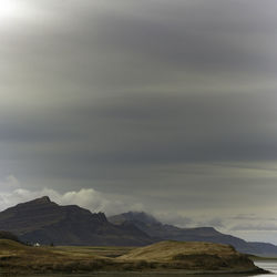 Scenic view of mountains against cloudy sky