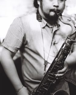 Midsection of man playing guitar