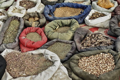 0111 sacks containing seeds-grains-herbs placed on the ground. sunday market-hotan-xinjiang-china.